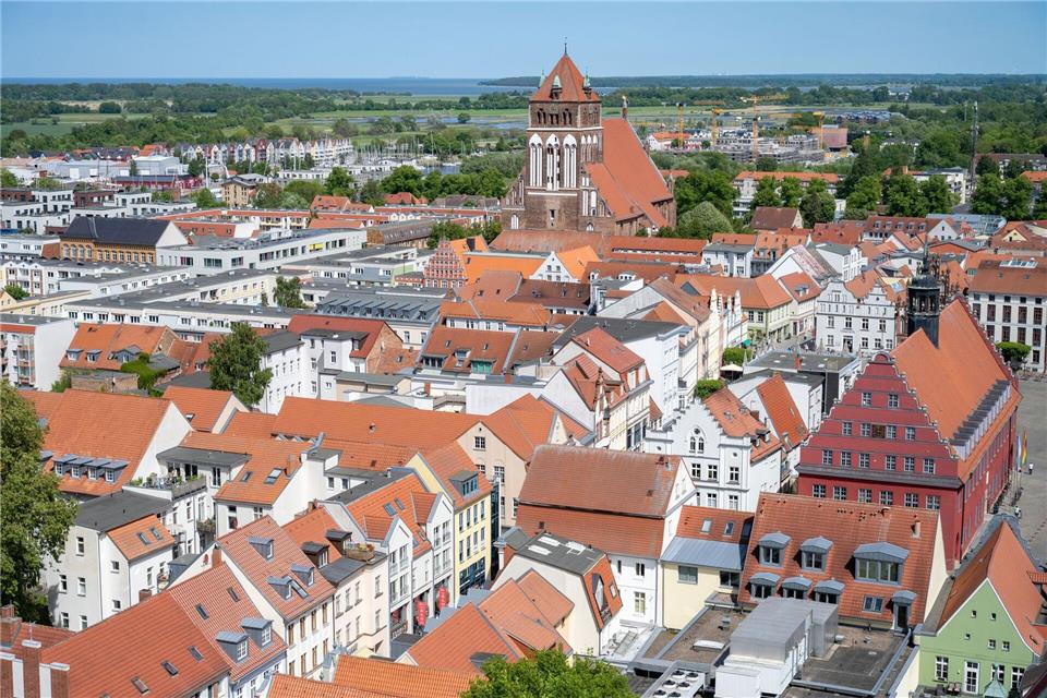 Gruppe Kinder halten einen Stadtplan und zeigen auf ein Street Point Ziel
